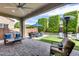 Inviting outdoor patio with a dining area, comfortable seating, and lush landscaping at 214 W Beverly Ln, Phoenix, AZ 85023
