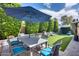 Backyard with seating, well-manicured landscaping, and outdoor dining under a blue umbrella at 214 W Beverly Ln, Phoenix, AZ 85023