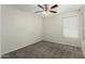 Bedroom features neutral carpeting and a ceiling fan at 21621 N 48Th Pl, Phoenix, AZ 85054