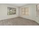 A bright bedroom with carpet and two windows providing natural light at 21621 N 48Th Pl, Phoenix, AZ 85054
