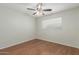 The bedroom has a ceiling fan and wood flooring at 21621 N 48Th Pl, Phoenix, AZ 85054