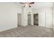 Spacious bedroom with neutral carpet, ceiling fan, and ample closet space at 21621 N 48Th Pl, Phoenix, AZ 85054