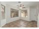Bright dining room with tile floors, a ceiling fan, and natural light from large windows at 21621 N 48Th Pl, Phoenix, AZ 85054