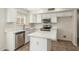 Bright kitchen featuring modern white cabinets, stainless steel appliances, and an island at 21621 N 48Th Pl, Phoenix, AZ 85054