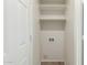 Bright laundry room features built-in shelving and washer/dryer hookups at 21621 N 48Th Pl, Phoenix, AZ 85054