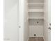 Bright laundry room features built-in shelving and washer/dryer hookups at 21621 N 48Th Pl, Phoenix, AZ 85054