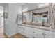 Stylish bathroom features dual sinks, framed mirrors, and updated cabinetry at 22346 N 104Th Ln, Peoria, AZ 85383