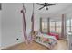 A bedroom featuring a bed, ceiling fan, and window with shutters for plenty of natural light at 22346 N 104Th Ln, Peoria, AZ 85383