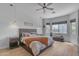 Relaxing bedroom with wood-look floors, ceiling fan, and large window for natural light at 22346 N 104Th Ln, Peoria, AZ 85383