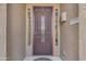 A close-up view of the front door featuring a decorative security screen and unique signage at 22346 N 104Th Ln, Peoria, AZ 85383