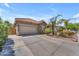 Single-story home boasts low-maintenance landscaping, a driveway, and an attached two-car garage at 22346 N 104Th Ln, Peoria, AZ 85383