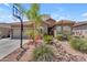 Charming single story home featuring desert landscaping, a basketball hoop, and a tile roof at 22346 N 104Th Ln, Peoria, AZ 85383