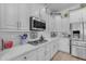 Well-appointed kitchen featuring granite countertops, stainless steel appliances, and bright, white cabinetry at 22346 N 104Th Ln, Peoria, AZ 85383