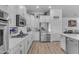 Well-lit kitchen with stainless steel appliances, white cabinets, granite countertops, and a subway tile backsplash at 22346 N 104Th Ln, Peoria, AZ 85383
