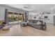 Open-concept living room boasts a seamless flow to a pristine kitchen and outdoor patio with pool at 22346 N 104Th Ln, Peoria, AZ 85383