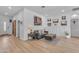 Bright living room features paneled walls, wood floors, and a cozy seating area with modern decor at 22346 N 104Th Ln, Peoria, AZ 85383