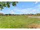 Expansive green park with mature trees, a basketball court, and walking paths at 22346 N 104Th Ln, Peoria, AZ 85383