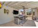 Beautiful outdoor patio featuring an outdoor kitchen with bar seating and a mounted television at 22346 N 104Th Ln, Peoria, AZ 85383