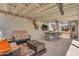 Covered patio featuring comfortable seating, an outdoor kitchen, and a large television at 22346 N 104Th Ln, Peoria, AZ 85383