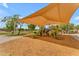Community playground with colorful play structures, slides, and a shade canopy at 22346 N 104Th Ln, Peoria, AZ 85383
