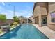 Inviting pool area with a swim-up bar, lush landscaping, and desert architecture at 22346 N 104Th Ln, Peoria, AZ 85383