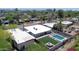 Aerial view of backyard with pool, seating area, and artificial turf, surrounded by block fence at 2320 E Mulberry Dr, Phoenix, AZ 85016