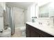 Bright bathroom featuring a marble tiled shower, modern vanity, and decorative accents at 2320 E Mulberry Dr, Phoenix, AZ 85016