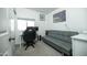 Cozy room with grey walls, carpet floor, grey futon, and a window for natural light at 2320 E Mulberry Dr, Phoenix, AZ 85016