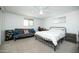 Bright bedroom with white walls, carpet floor, futon, a ceiling fan, and a black metal bed frame at 2320 E Mulberry Dr, Phoenix, AZ 85016