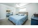 Calm bedroom with blue bedding, ceiling fan, carpet flooring, and mirrored closet at 2320 E Mulberry Dr, Phoenix, AZ 85016