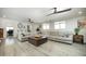Open living room with a large sectional, hardwood floors, and bright windows at 2320 E Mulberry Dr, Phoenix, AZ 85016