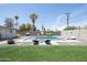 Backyard pool featuring lounge chairs, umbrella, and well-manicured artificial turf at 2320 E Mulberry Dr, Phoenix, AZ 85016