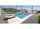 Backyard with swimming pool, patio, artificial grass, hardscape, and lush landscaping at 2320 E Mulberry Dr, Phoenix, AZ 85016