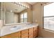 Bathroom with a double sink vanity, well lit with decorative light fixture and natural lighting at 2893 E Cherry Hills Dr, Chandler, AZ 85249