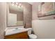 Cozy bathroom featuring a vanity sink, a toilet, and simple neutral decor at 2893 E Cherry Hills Dr, Chandler, AZ 85249