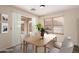 Staged dining room with a sliding glass door, gray tile floor, wood table, and chairs at 2893 E Cherry Hills Dr, Chandler, AZ 85249