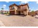 Two-story home featuring a brown-tone stucco exterior, a two-car garage, and a low-maintenance front yard at 2893 E Cherry Hills Dr, Chandler, AZ 85249