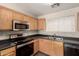 Functional kitchen features wood cabinetry, stainless steel appliances, and plenty of counter space at 2893 E Cherry Hills Dr, Chandler, AZ 85249