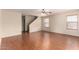 Living room with hardwood floors, a ceiling fan, and a view to the stairs at 2893 E Cherry Hills Dr, Chandler, AZ 85249