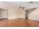 Living room featuring hardwood floors, a ceiling fan, neutral paint, and two entry doors at 2893 E Cherry Hills Dr, Chandler, AZ 85249