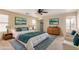 Comfortable primary bedroom with ceiling fan, art, and an ensuite bathroom at 2893 E Cherry Hills Dr, Chandler, AZ 85249
