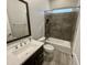 Bathroom showcases a tiled shower-over-tub, a modern vanity, and stylish fixtures, creating a relaxing and functional space at 32978 N 131St Dr, Peoria, AZ 85383