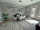 Dining area featuring modern table set, a large window, and wood look tile flooring at 32978 N 131St Dr, Peoria, AZ 85383