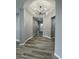 Inviting home foyer with a stylish ceiling light and wood look tile at 32978 N 131St Dr, Peoria, AZ 85383