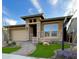 Charming single-story home with stone accents, desert landscaping, a paver walkway, and a two-car garage at 32978 N 131St Dr, Peoria, AZ 85383
