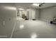 The spacious garage features a sealed concrete floor and room for storage and vehicles at 32978 N 131St Dr, Peoria, AZ 85383