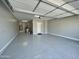 Spacious two-car garage featuring an epoxy floor, white walls, and overhead door, creating a clean and functional space at 32978 N 131St Dr, Peoria, AZ 85383