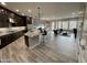 Open-concept kitchen with a large island, stainless appliances, and plenty of counter space flowing into the living area at 32978 N 131St Dr, Peoria, AZ 85383