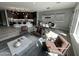 Spacious open-concept living room featuring stylish furniture, a dining area, and a modern kitchen at 32978 N 131St Dr, Peoria, AZ 85383