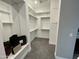 Walk-in closet equipped with multiple shelves and racks providing lots of storage space for clothes at 32978 N 131St Dr, Peoria, AZ 85383
